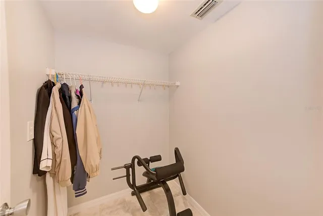 a view of walk in closet with clothes