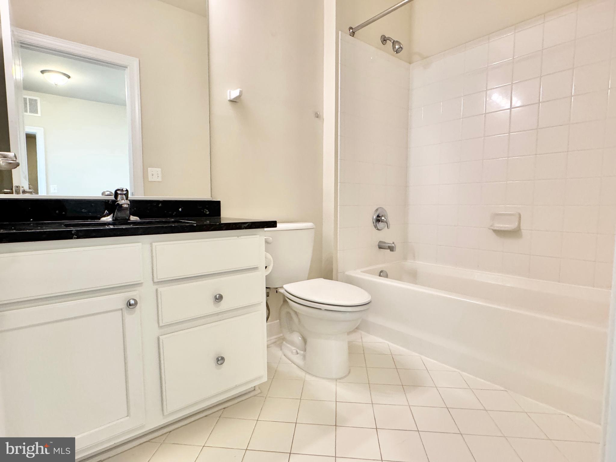2304 Margraf Circle Woodbridge, VA 22191 - Photo 22 of 27 a bathroom with a granite countertop sink a toilet a mirror and shower