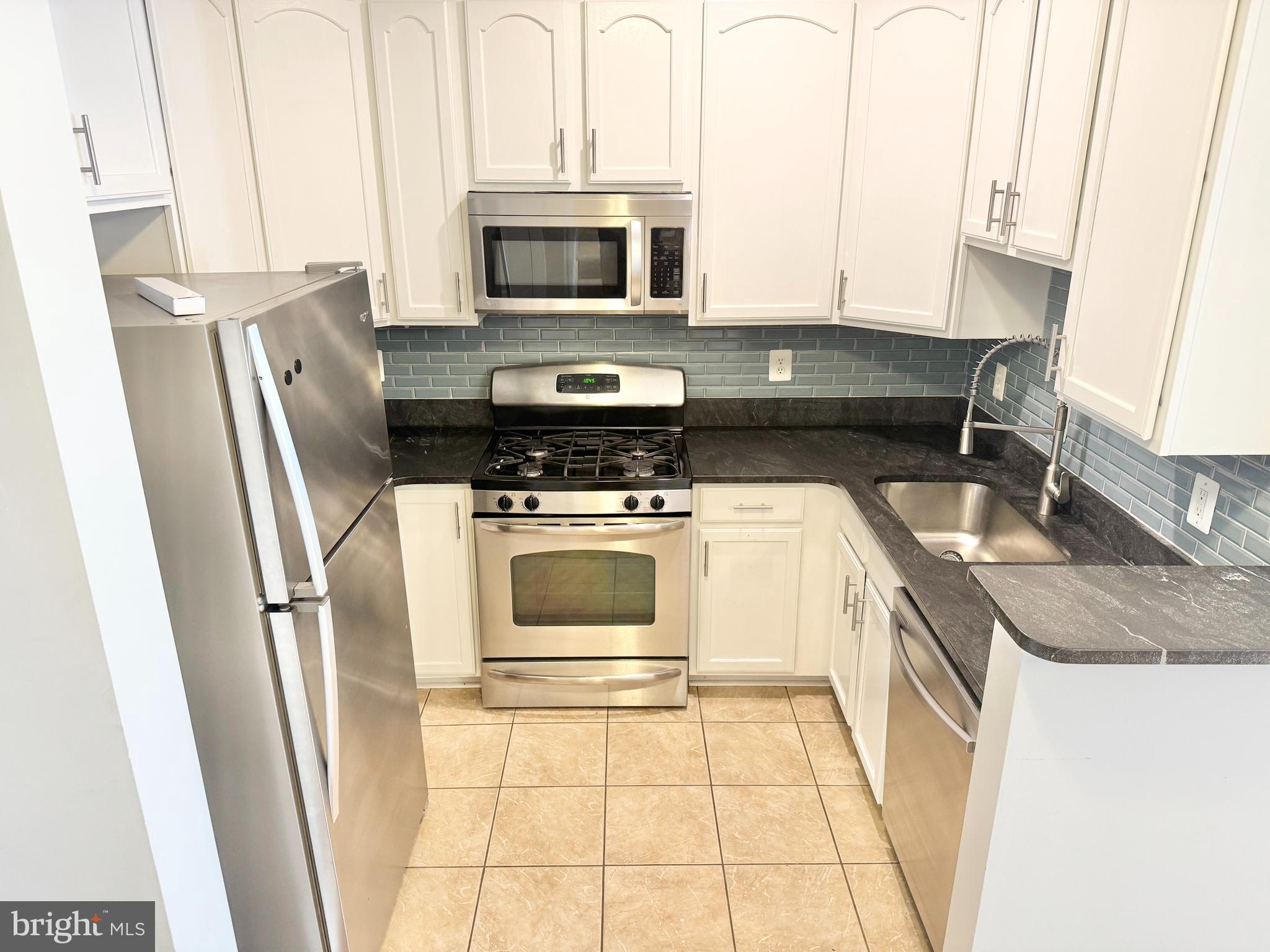 2304 Margraf Circle Woodbridge, VA 22191 - Photo 7 of 27 a kitchen with a stove microwave and sink