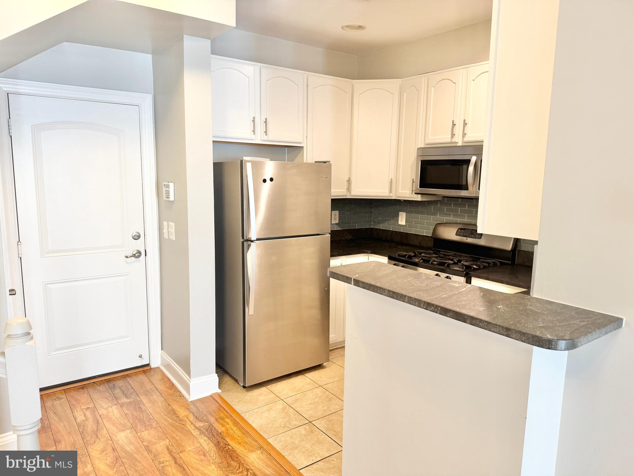 2304 Margraf Circle Woodbridge, VA 22191 - Photo 9 of 27 a kitchen with a refrigerator a stove and a microwave