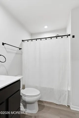 a bathroom with a toilet a sink and shower