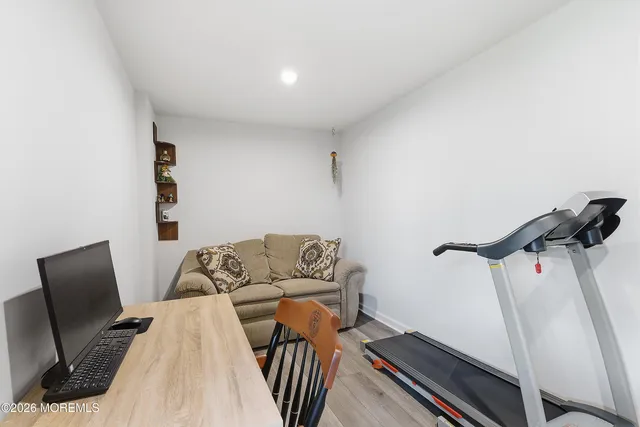 a view of a room with furniture and wooden floor