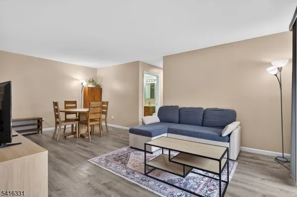 a living room with furniture a dining table and a piano table