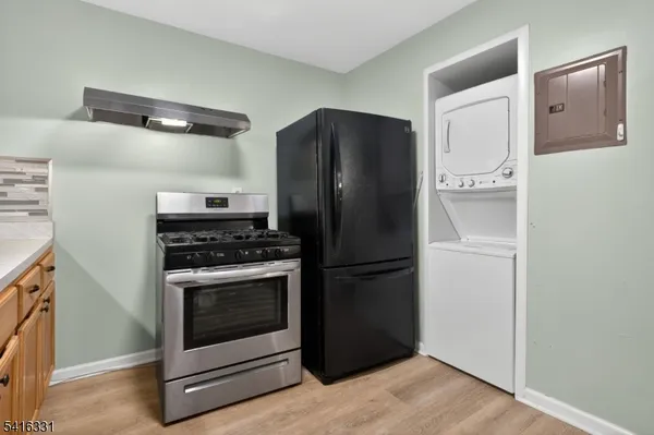 a kitchen with a refrigerator and a stove