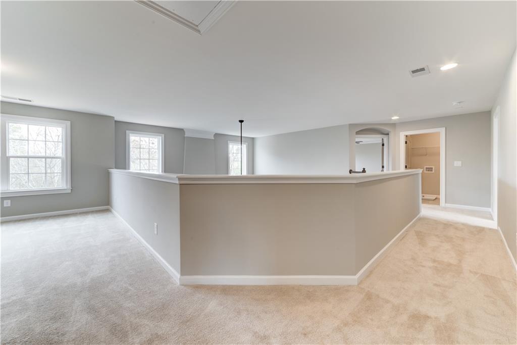 6145 Grindle Road Cumming, GA 30041 - Photo 15 of 20 an empty room with windows and chandelier