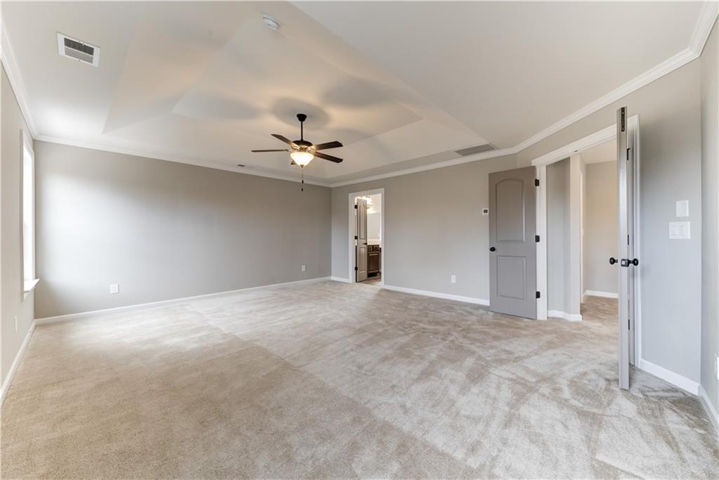 6145 Grindle Road Cumming, GA 30041 - Photo 18 of 20 a view of an empty room with a chandelier fan