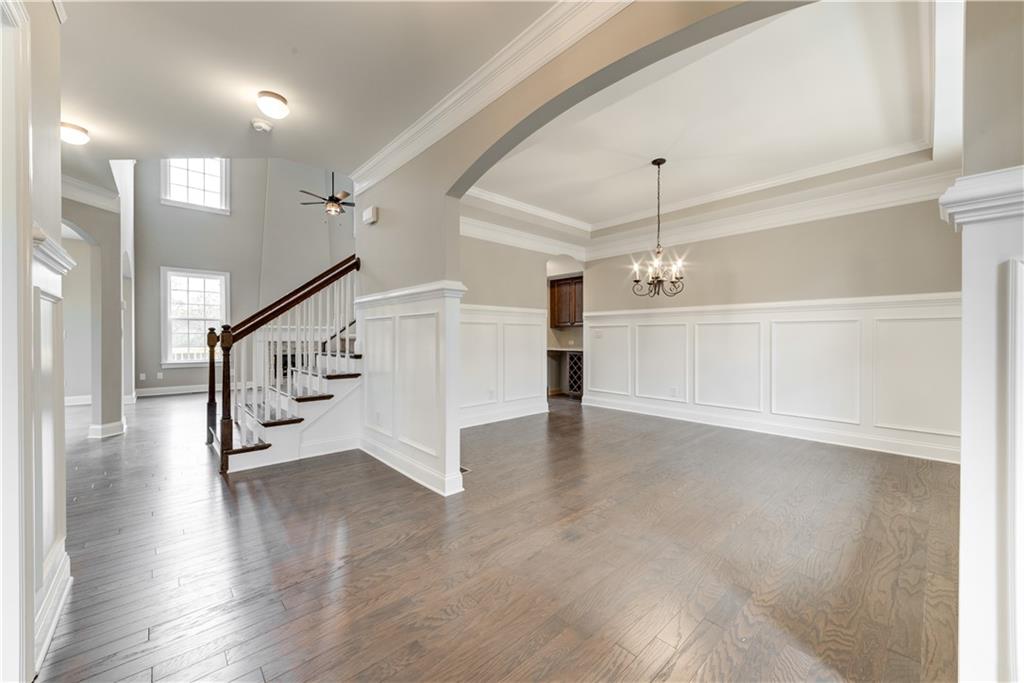 6145 Grindle Road Cumming, GA 30041 - Photo 7 of 20 a view of a hallway with stairs and wooden floor