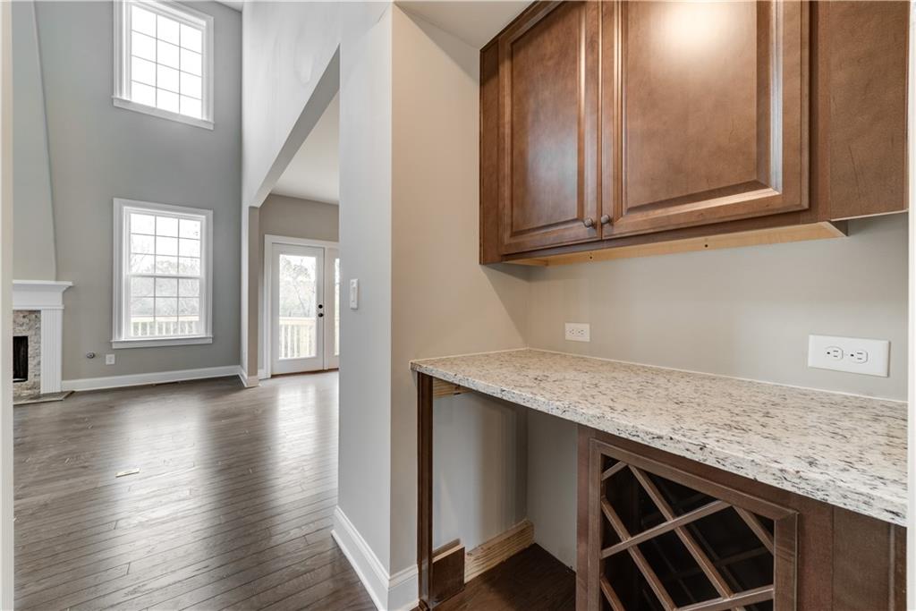 6145 Grindle Road Cumming, GA 30041 - Photo 9 of 20 an empty room with wooden floor and cabinets