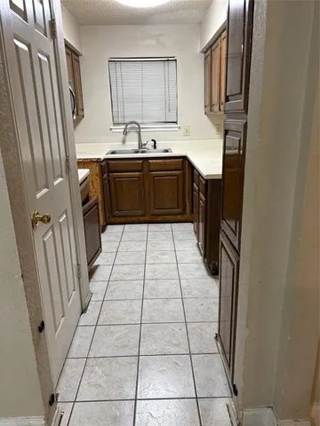 a kitchen with stainless steel appliances a sink stove and a refrigerator