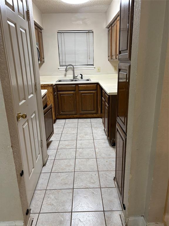 823 West Harwood Road Hurst, TX 76054 - Photo 3 of 8 a kitchen with stainless steel appliances a sink stove and a refrigerator