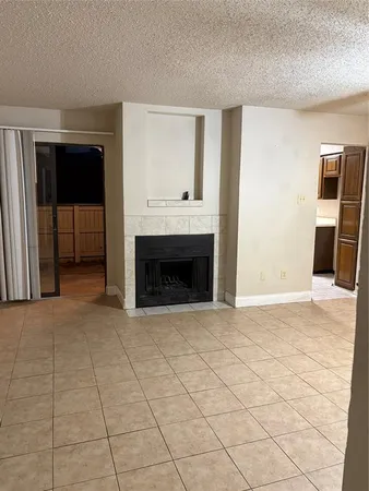 a view of empty room with wooden floor and fireplace