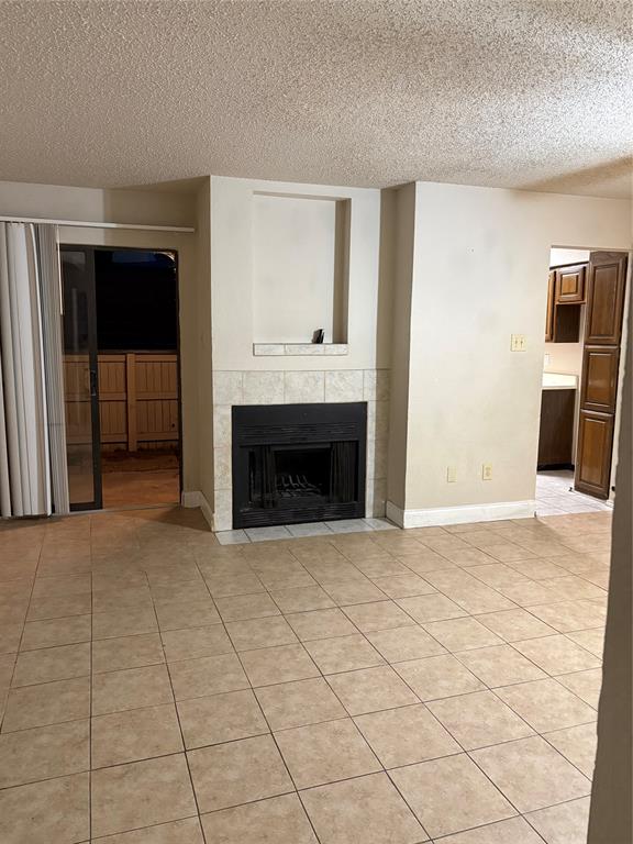 823 West Harwood Road Hurst, TX 76054 - Photo 7 of 8 a view of empty room with wooden floor and fireplace