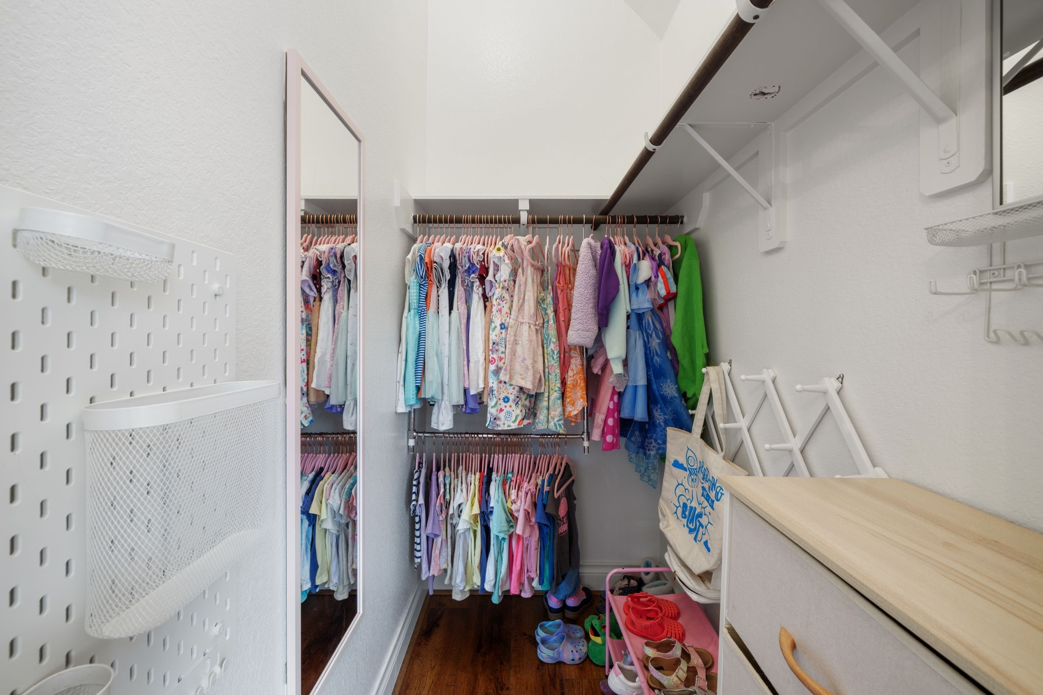 2119 Blackhawk Ridge Lane Manvel, TX 77578 - Photo 26 of 49 Spacious walk-in closet with double hanging rods, pegboard wall organizers, and ample floor space — offering generous storage for any wardrobe.
