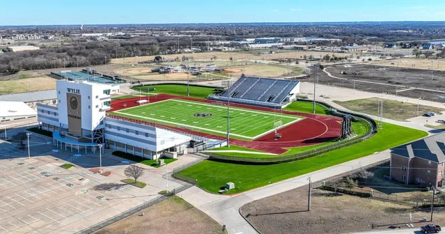 an aerial view of a house with a garden and lake view