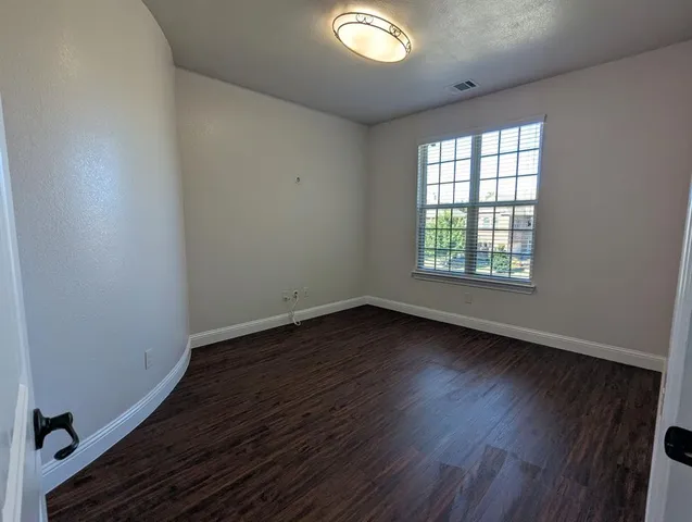 a kitchen with a sink a counter space and a wooden floor