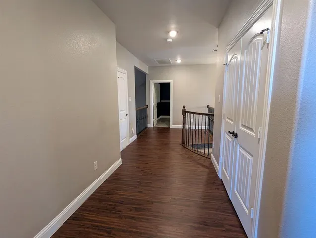 a room with stairs and wooden floor