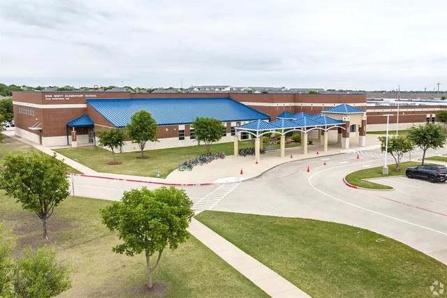 an aerial view of a house with a garden and lake view