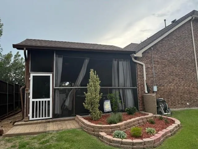 a backyard of a house with fountain table and chairs