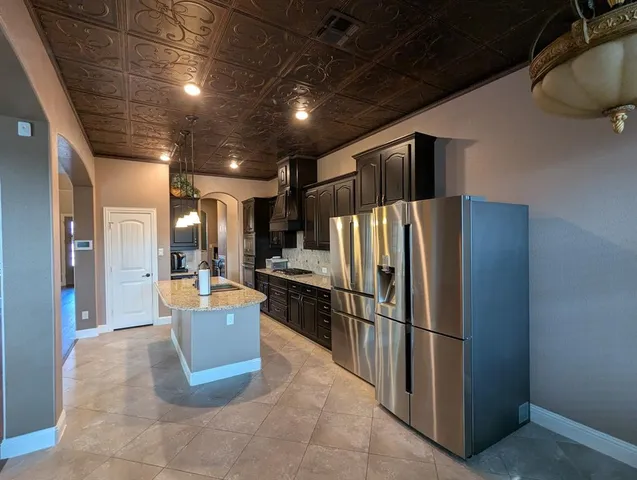 a refrigerator freezer sitting inside of a kitchen