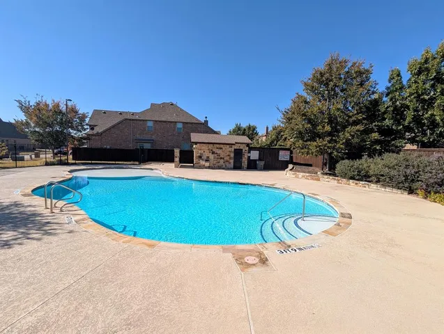 a view of a swimming pool with a yard