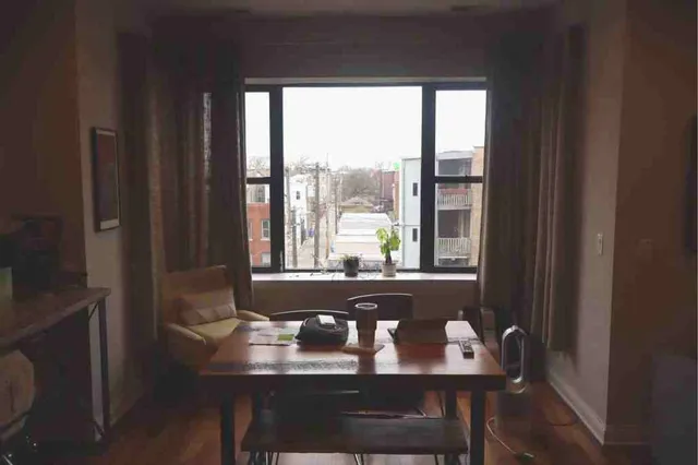 a view of a dining room with furniture and window