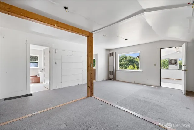 an empty room with windows and closet