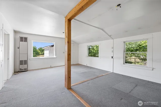 an empty room with windows and entrance