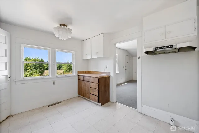 a kitchen with a refrigerator and window
