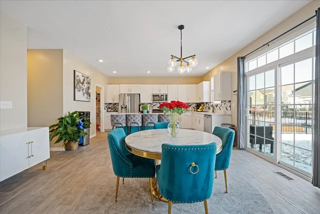 a living room with furniture a table and kitchen view