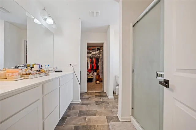a white toilet sitting next to a shower