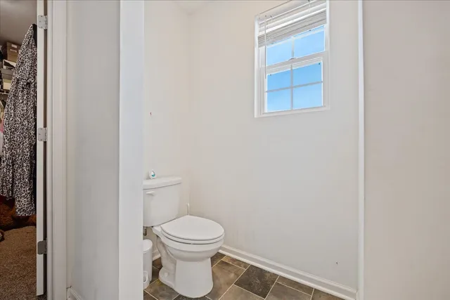 a bathroom with a toilet and a bathtub