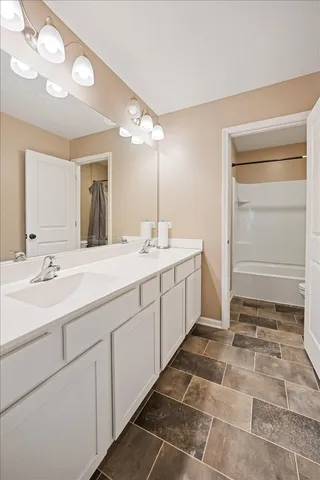 a room with a sink and mirror