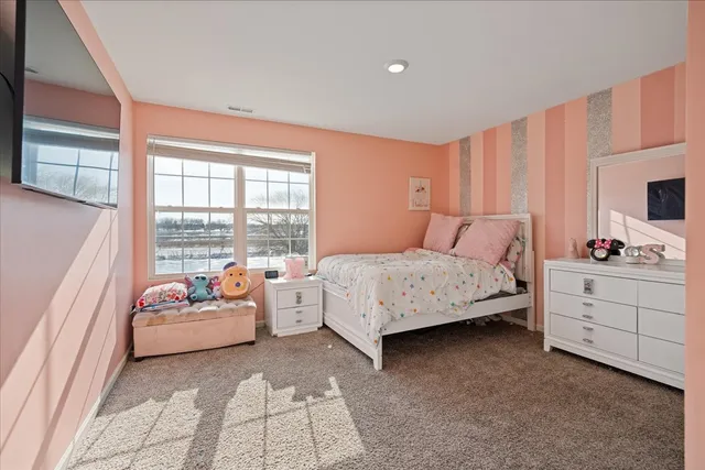 a bedroom with a bed couch and a window