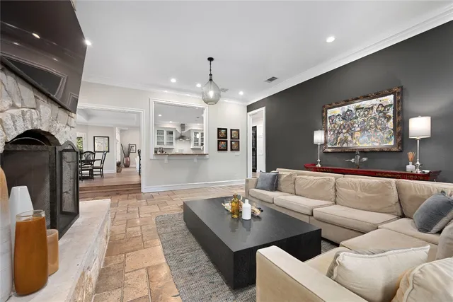 a living room with fireplace furniture and a flat screen tv