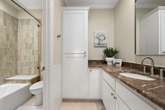 a bedroom with a bed a couch and dresser