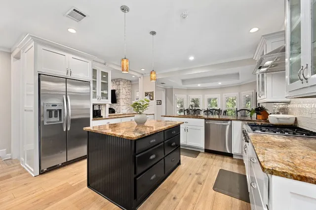 a kitchen with granite countertop stainless steel appliances and wooden cabinets