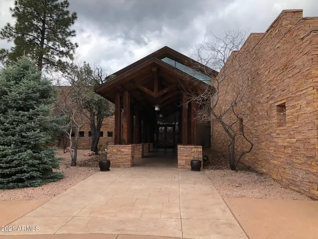 a living room filled with furniture and floor to ceiling windows