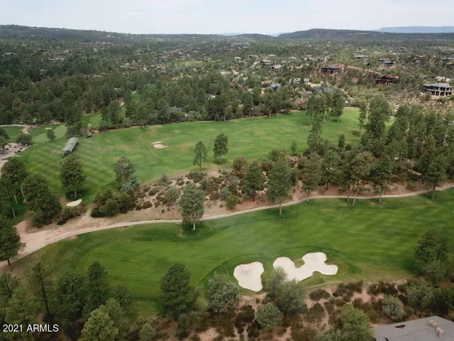 a view of a green field with lots of trees