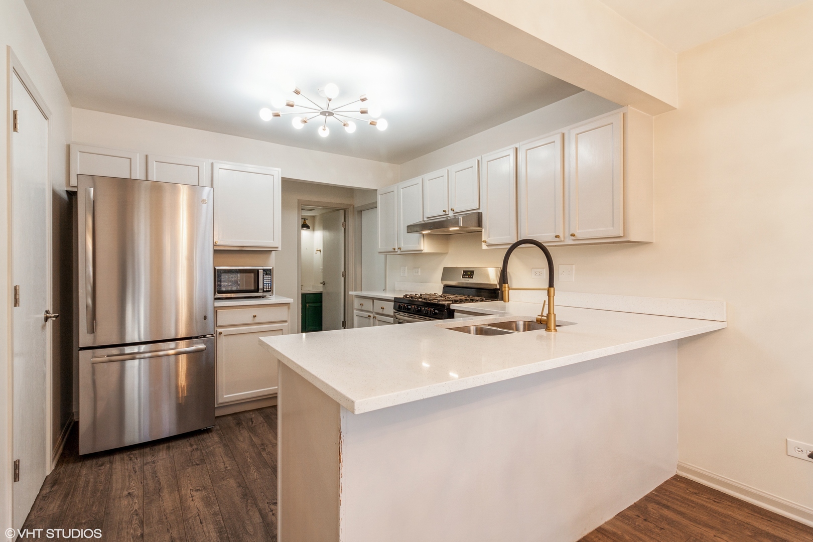 955 Elderberry Circle, Unit 111 Naperville, IL 60563 - Photo 4 of 11 a kitchen with stainless steel appliances a refrigerator sink and cabinets