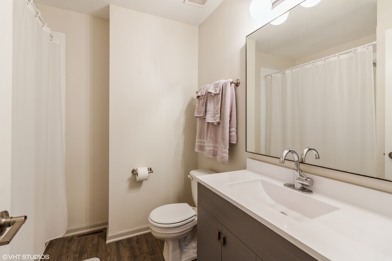 955 Elderberry Circle, Unit 111 Naperville, IL 60563 - Photo 9 of 11 a bathroom with a sink and a mirror