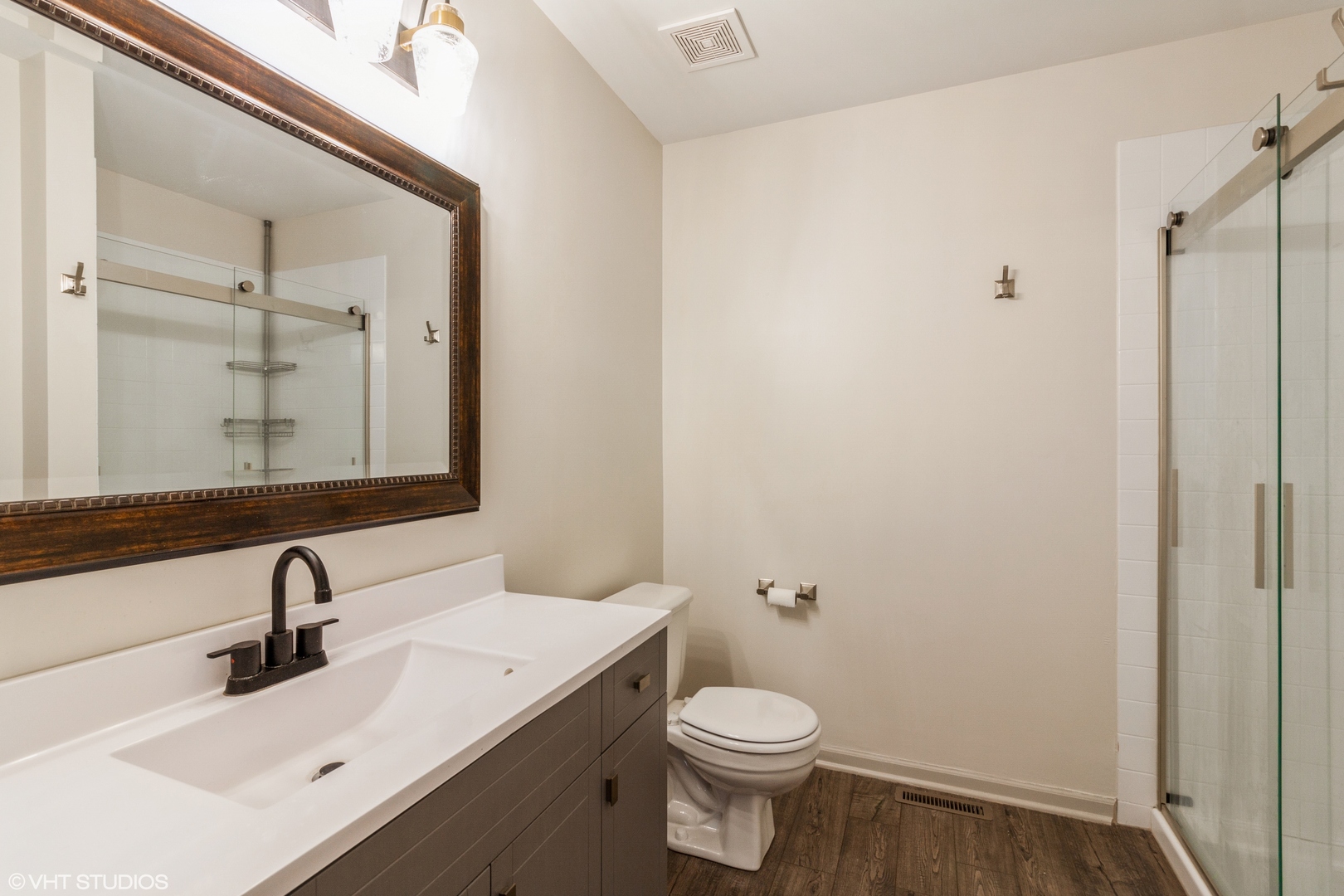 955 Elderberry Circle, Unit 111 Naperville, IL 60563 - Photo 10 of 11 a bathroom with a sink vanity mirror and toilet