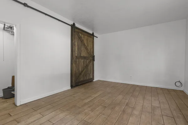 a view of an empty room and wooden floor
