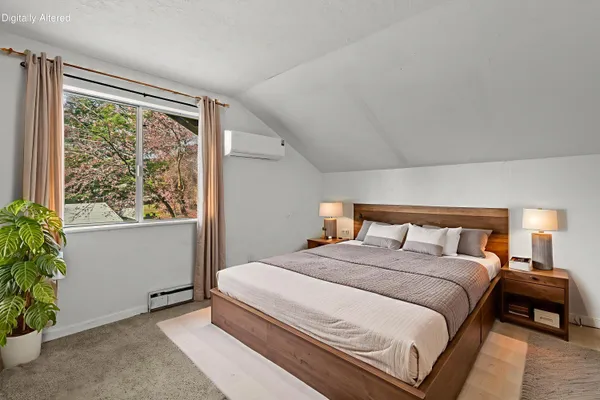 a bedroom with a large bed and a window