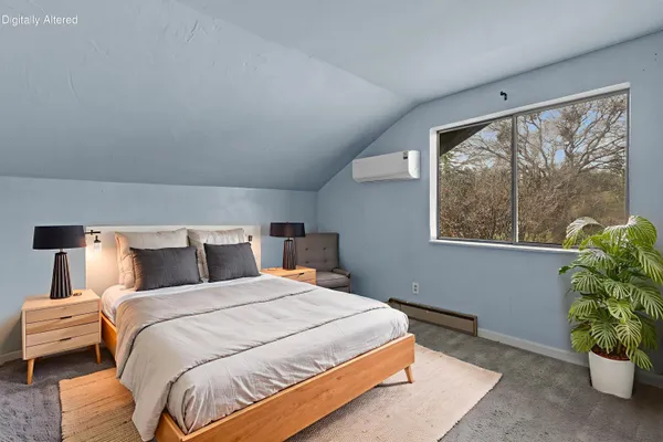 a bedroom with a bed and a potted plant