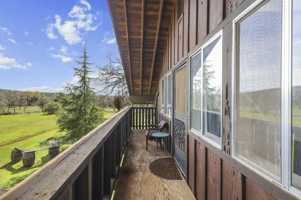 a view of balcony with yard