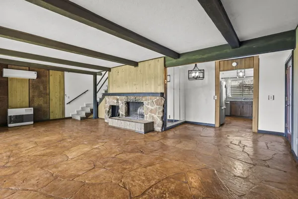 a view of empty room with furniture and windows