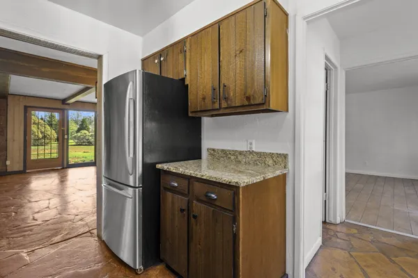 a kitchen with stainless steel appliances granite countertop a refrigerator and a sink