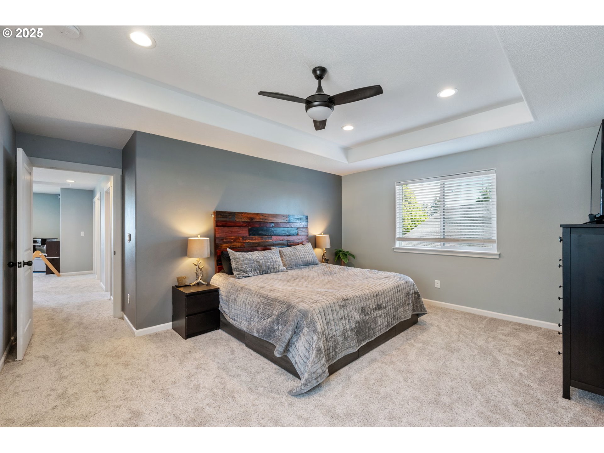 2820 Southeast Baker Avenue Gresham, OR 97080 - Photo 17 of 33 a bedroom with a large bed and a chandelier