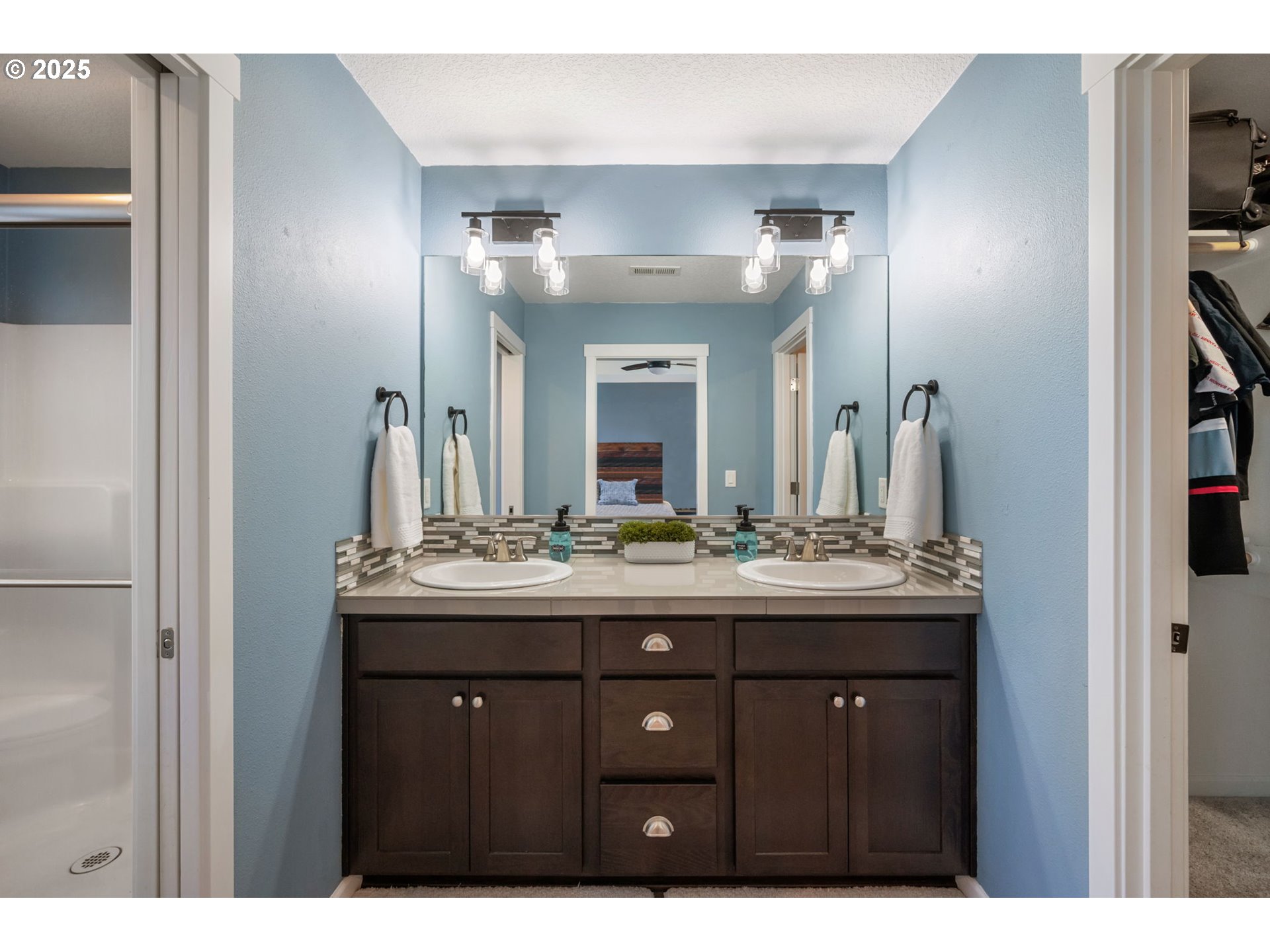 2820 Southeast Baker Avenue Gresham, OR 97080 - Photo 18 of 33 a bathroom with a granite countertop sink a large mirror and a