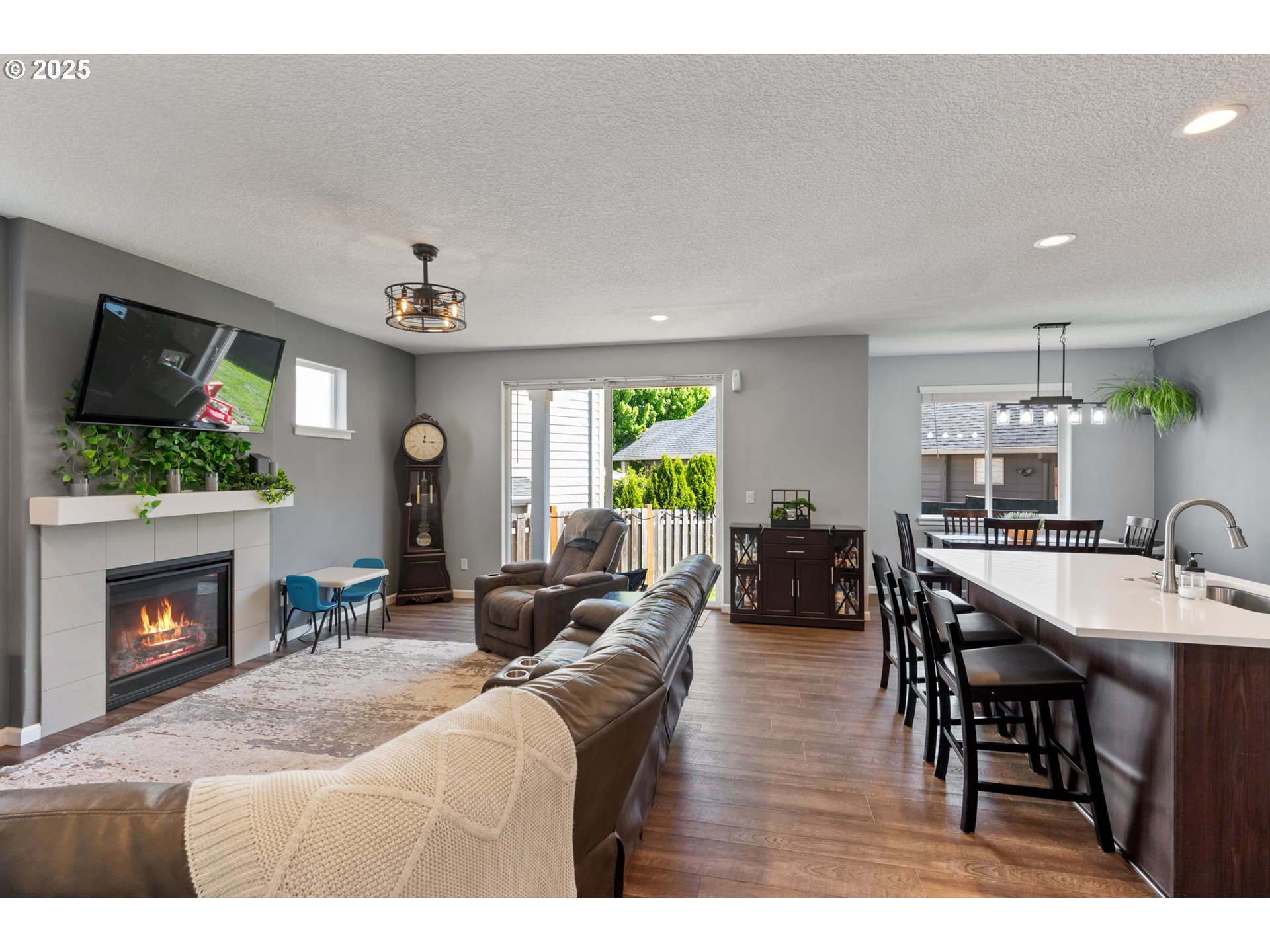 2820 Southeast Baker Avenue Gresham, OR 97080 - Photo 4 of 33 a living room with furniture a fireplace and a flat screen tv